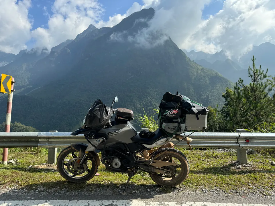BMW motorcycle beside a mountain road