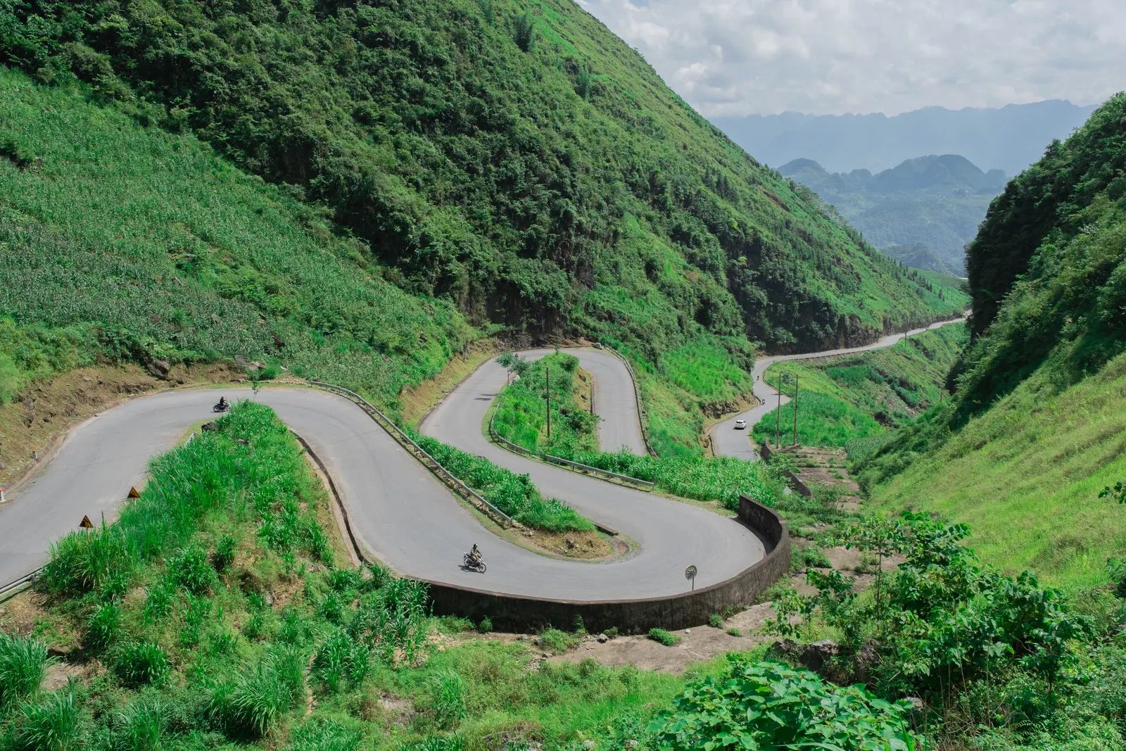 Aerial view of a mountain road in Ha Giang with motorcyclists