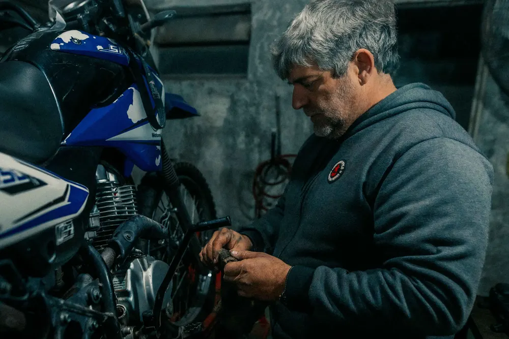 Mechanic working on a motorcycle in a garage